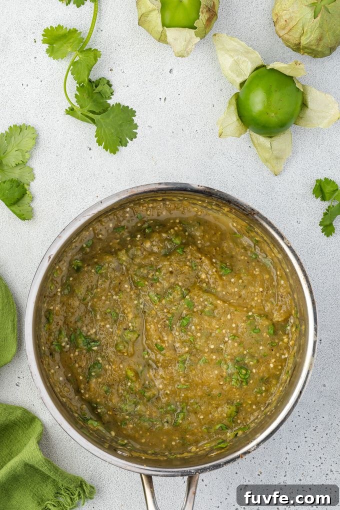 Homemade Green Enchilada Sauce with Tomatillos 6 Green enchilada sauce in pan with cilantro on top