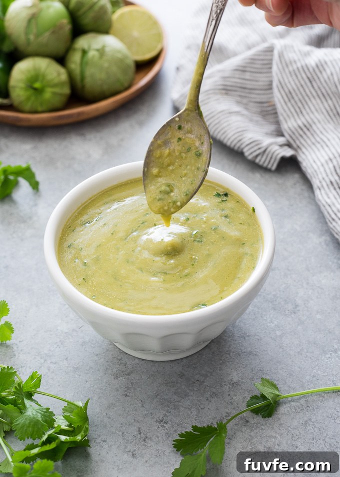 Homemade Green Enchilada Sauce with Tomatillos 8 Green enchilada sauce drizzling into a bowl