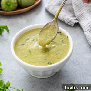 Homemade Green Enchilada Sauce with Tomatillos 9 Homemade green enchilada sauce pouring from a spoon