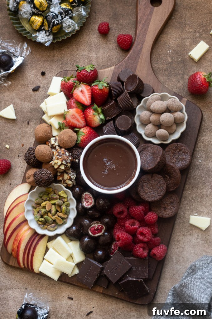 Chocolate charcuterie board with fruits, candies, truffles and more.