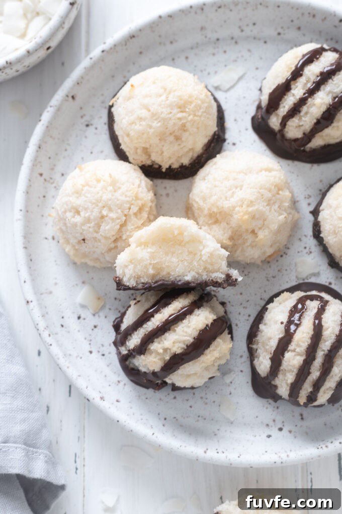 Coconut macaroons on a plate with one cut in half