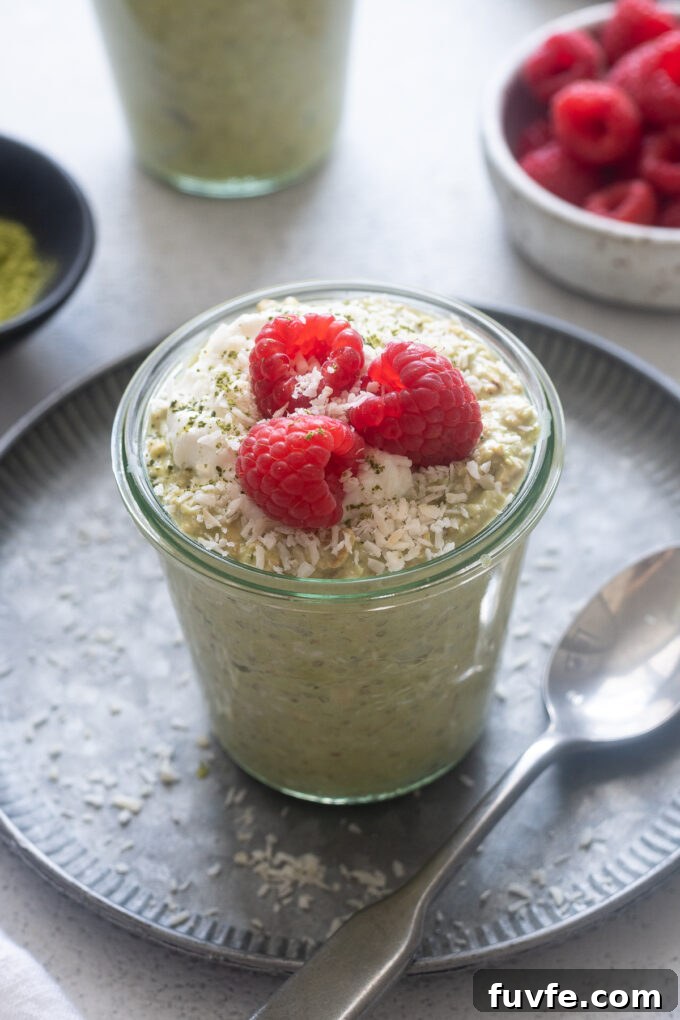 Matcha Overnight Oats Recipe: Creamy No-Cook Breakfast 2 Matcha overnight oats in a jar with raspberries on top.