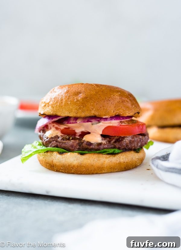 A classic grilled burger on a white plate. 