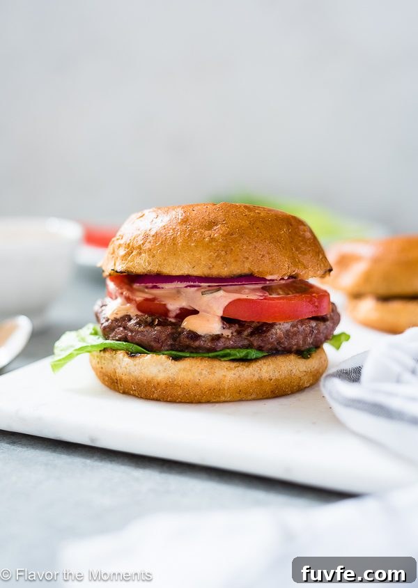 A juicy homemade burger on a white plate 
