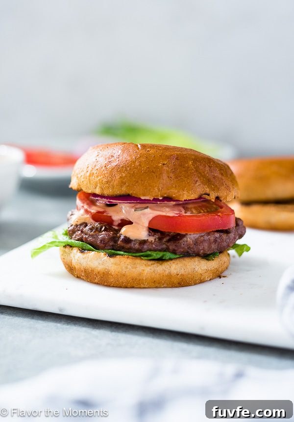 A grilled burger on a white plate 