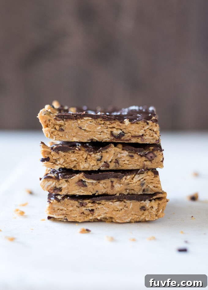 Stack of no bake peanut butter bars with cacao nibs.
