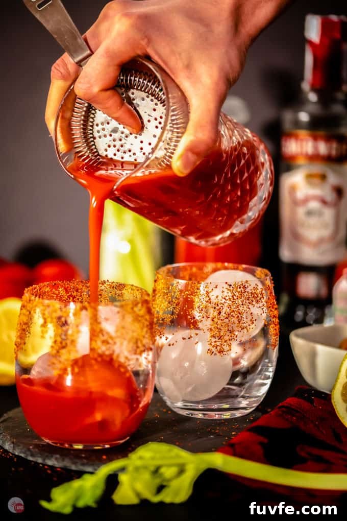 cocktail pouring over ice