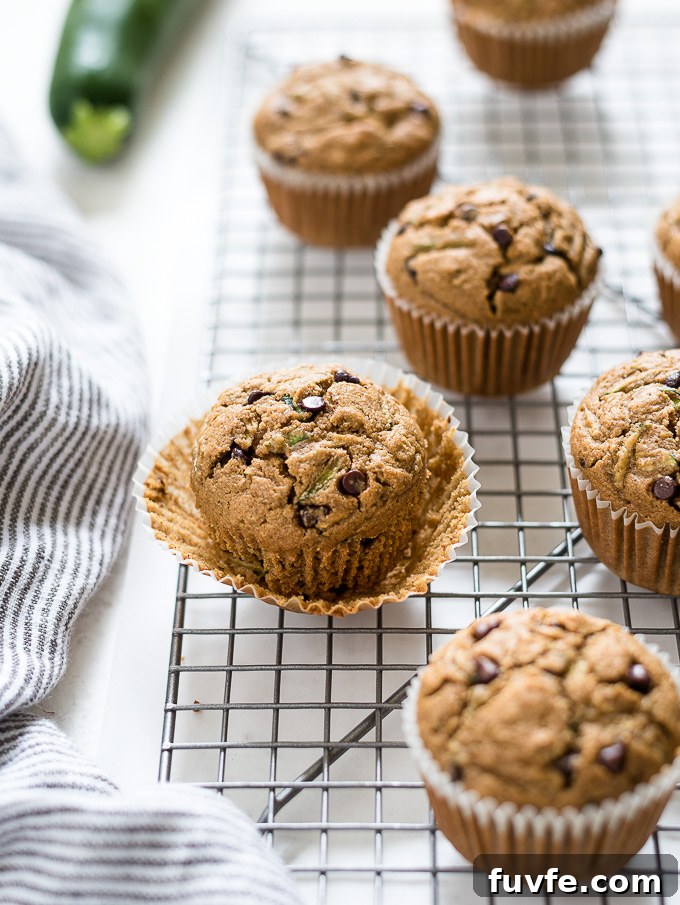 Oat Flour Zucchini Muffins Recipe - Moist and Fluffy 3 Gluten-free zucchini muffin with paper liner partially removed