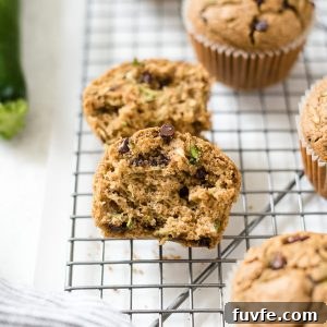 Oat Flour Zucchini Muffins Recipe - Moist and Fluffy 8 Oat flour zucchini chocolate chips muffins on a wire rack.