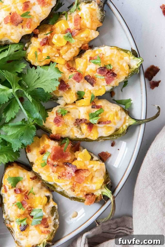 Corn dip stuffed jalapenos with bacon on top