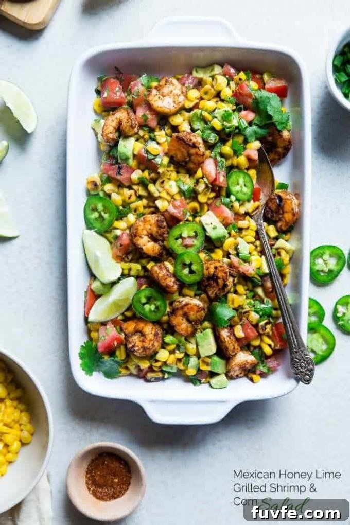 Baking dish of Mexican corn salad with honey lime shrimp.