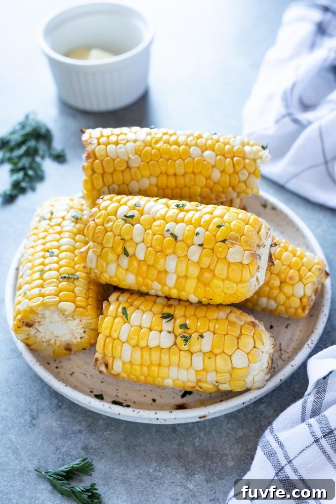 Air fryer corn on the cob piled on a white plate