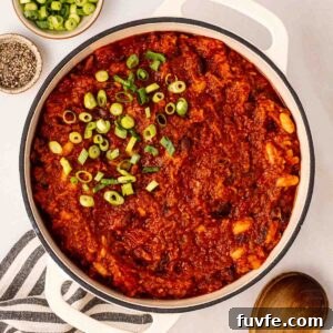 A big pan of Vegan Chilli with spring onions on top, ready to serve.