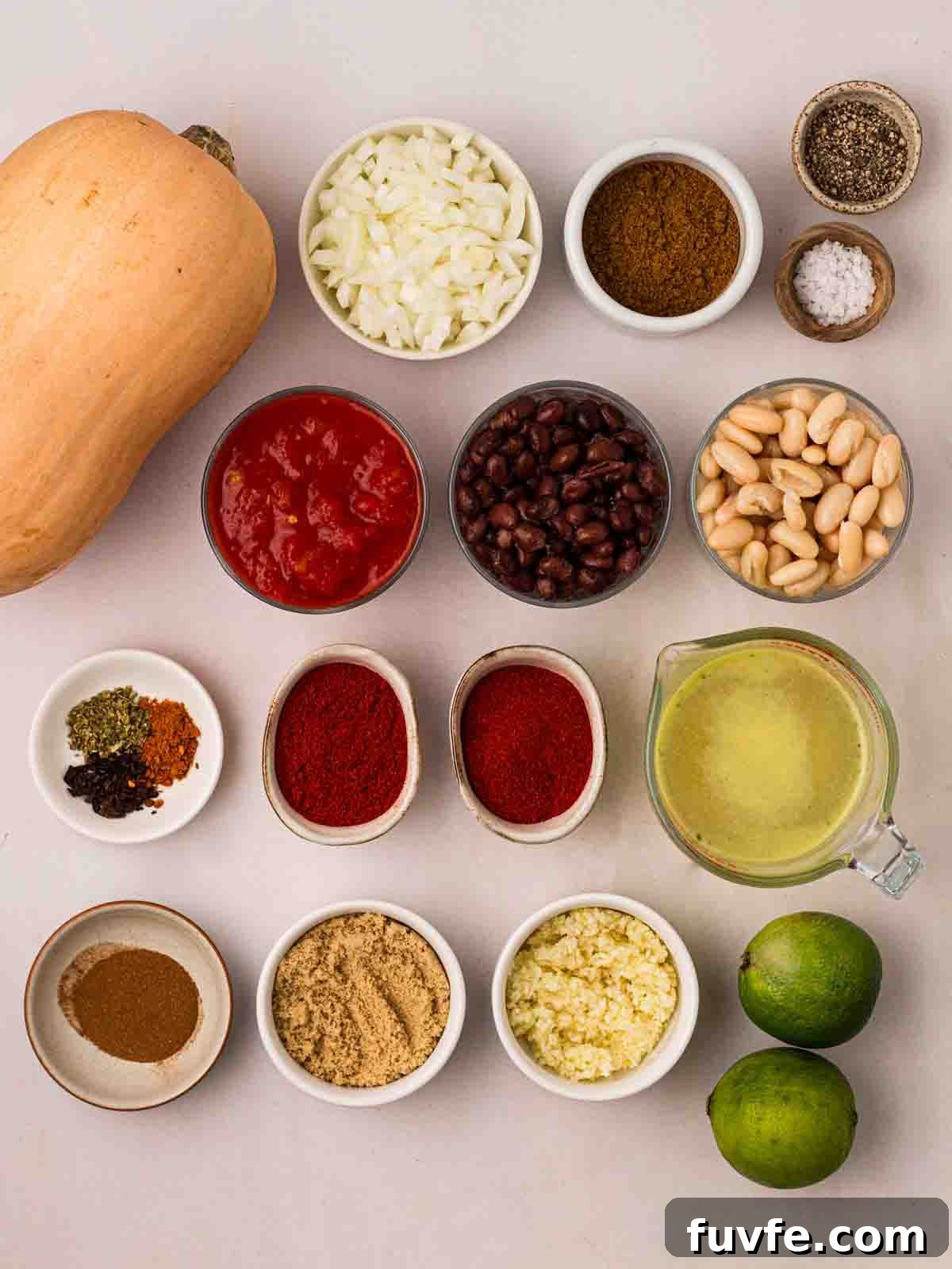 The ingredients for a Vegan Chilli recipe laid out on a counter in bowls.