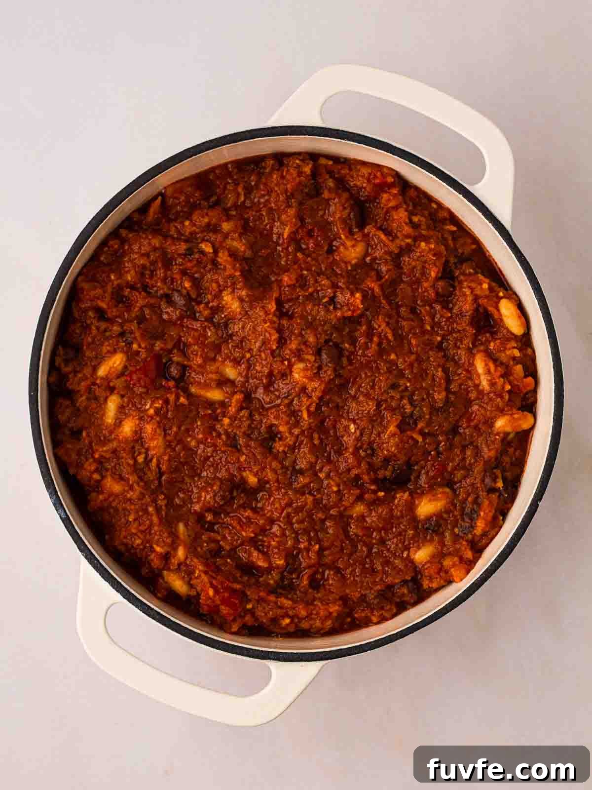 A pan filled with vegan chilli in the middle of cooking.