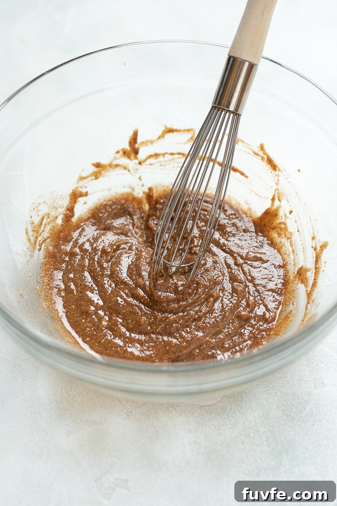 Combine wet ingredients for almond butter granola.
