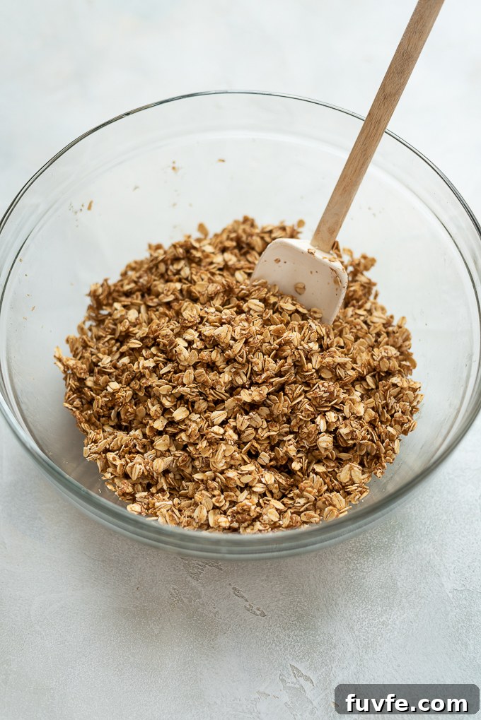 Almond butter granola in mixing bowl before baking.