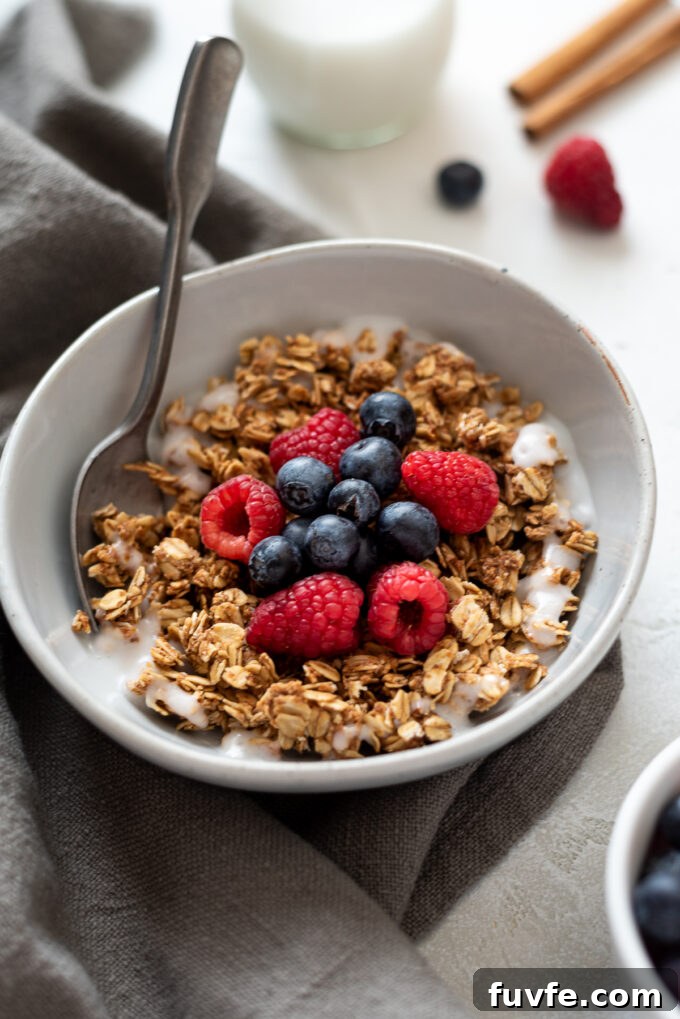 Crunchy Almond Butter Granola Recipe 8 Granola with almond butter in a bowl with milk and berries.