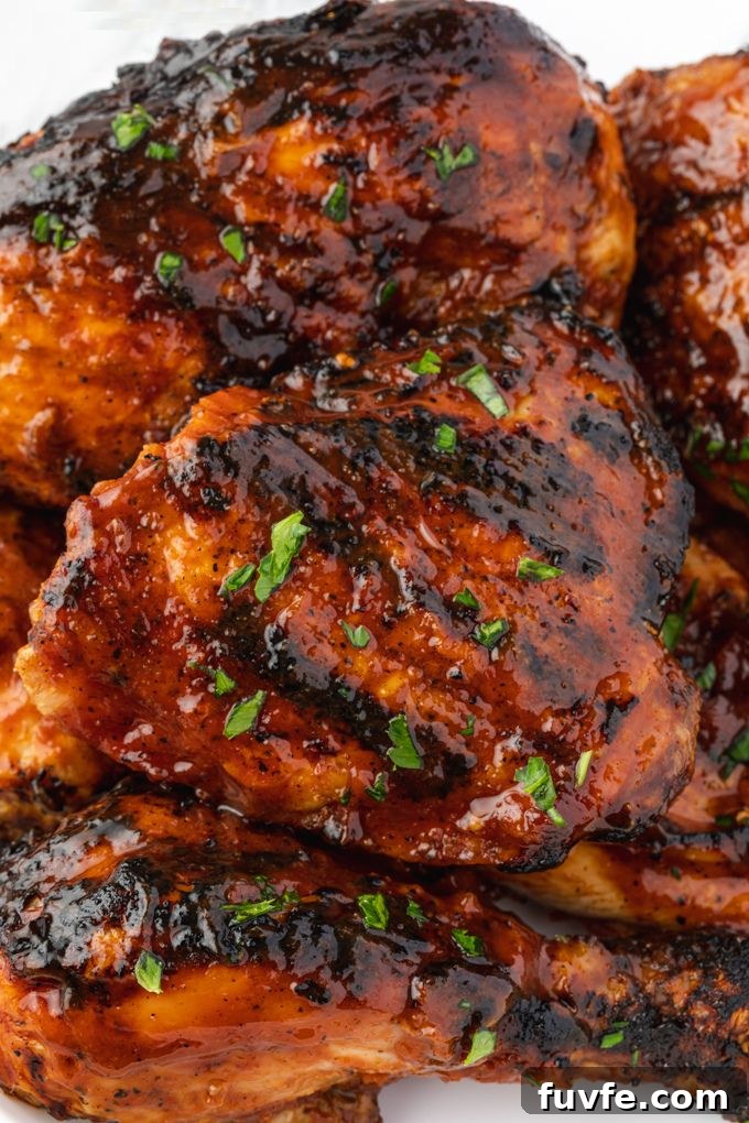 Juicy Smoky Grilled BBQ Chicken Recipe 7 Grilled bbq chicken on a platter with parsley