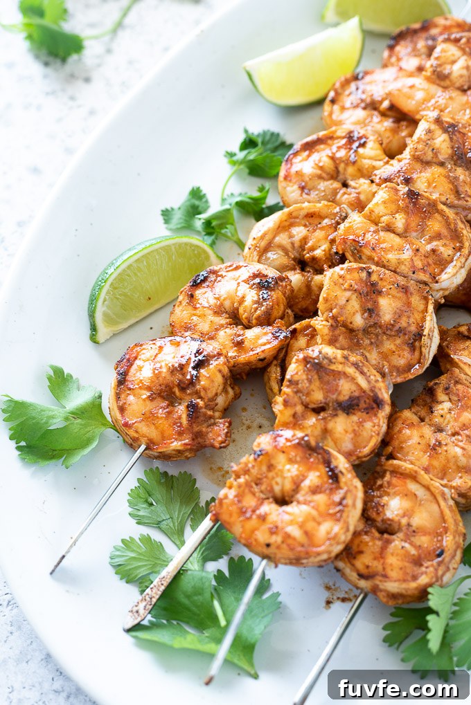 Grilled Chili-Lime Shrimp Skewers Recipe 7 Chili lime shrimp on a platter with lime and cilantro