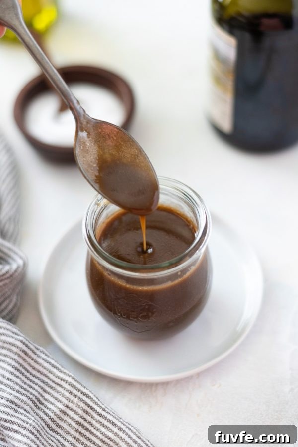 Homemade Balsamic Vinaigrette Recipe 4 overhead shot of balsamic vinaigrette dressing poured into a jar with a spoon