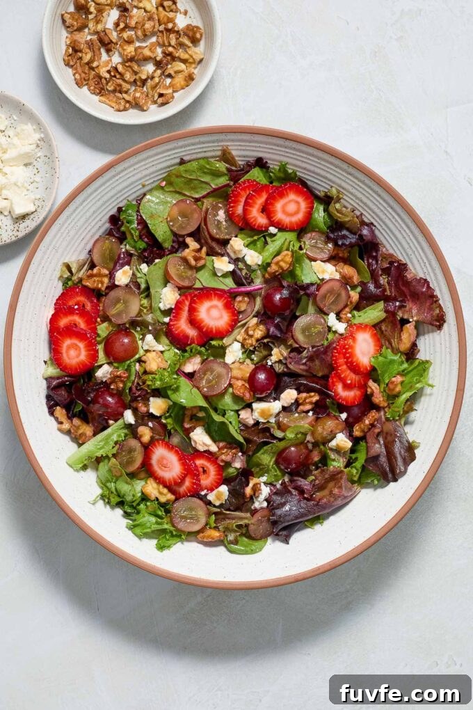 Strawberry Feta Spinach Salad with Balsamic Glaze 6 Strawberry spring mix salad in a serving bowl.