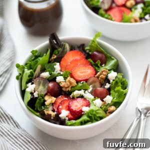 Strawberry feta salad in a white bowl.