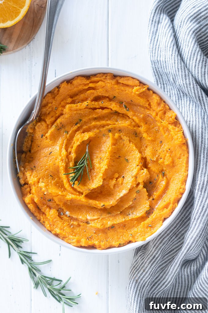Mashed sweet potatoes with rosemary sprig on top