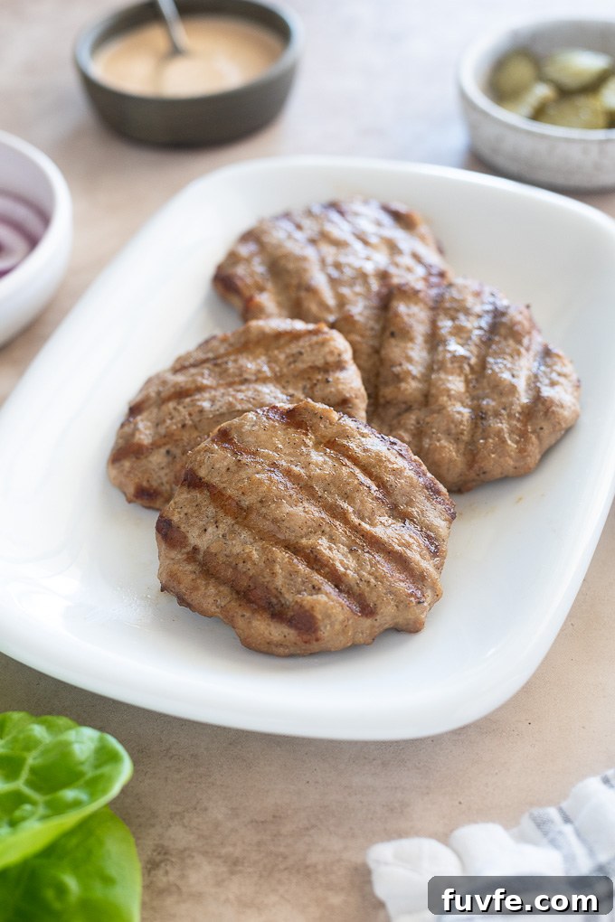 Grilled turkey burgers on a platter.