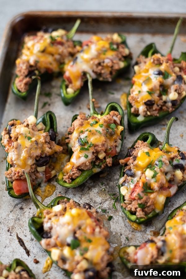 stuffed poblano peppers on a sheet pan