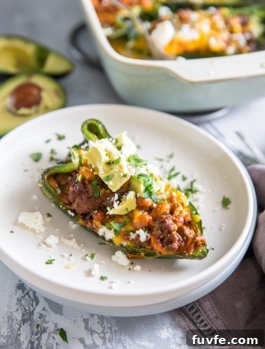 25 Poblano Pepper Recipes with Roasting and Storage Tips 25 A stuffed poblano pepper on a stack of white plates.