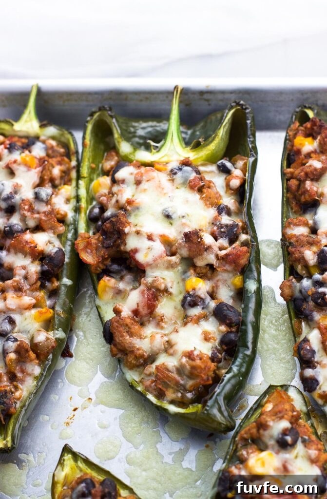 25 Poblano Pepper Recipes with Roasting and Storage Tips 30 Healthy stuffed poblano peppers on a baking tray.