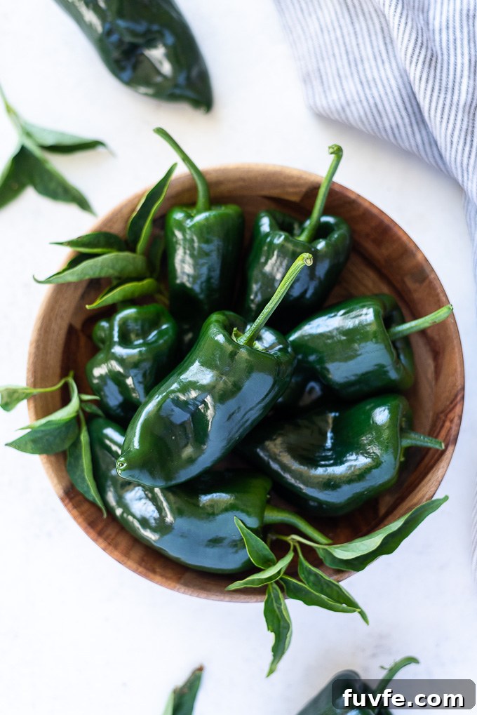 25 Poblano Pepper Recipes with Roasting and Storage Tips 4 Overhead view of poblano peppers in a teak bowl
