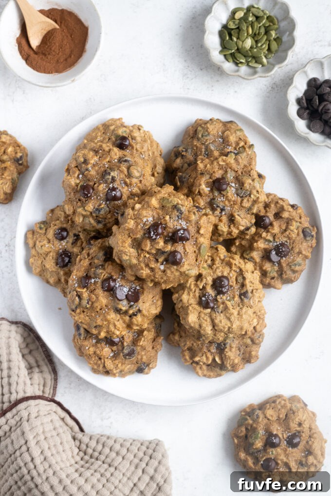 Pumpkin breakfast cookies piled on a white plate.