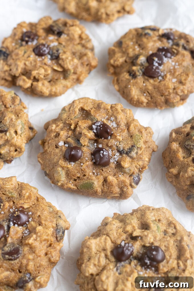 Pumpkin oatmeal breakfast cookies on parchment paper.