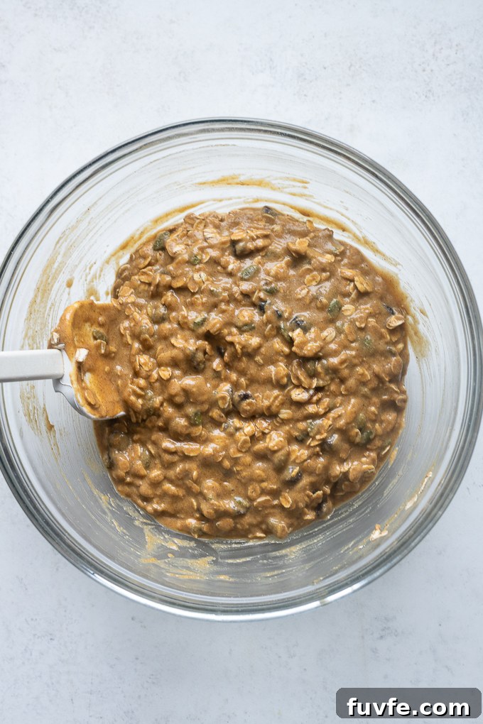 Pumpkin breakfast cookies batter in mixing bowl.