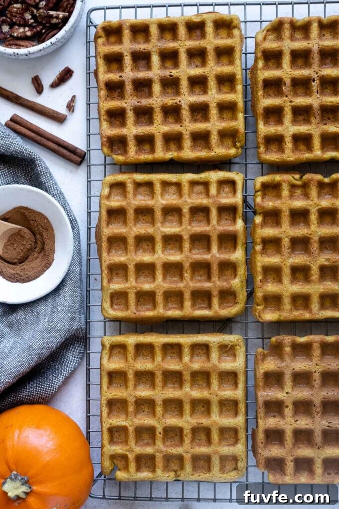 Whole grain pumpkin waffles on a wire rack.