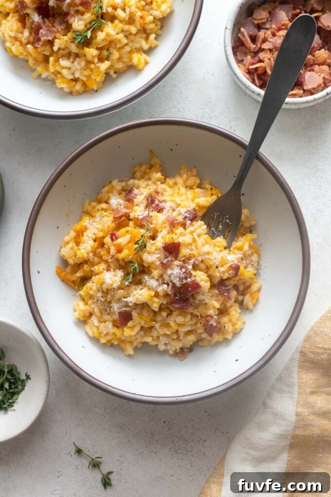 Creamy Pumpkin Risotto with Parmesan and Sage 6 Pumpkin risotto with bacon in a bowl with thyme sprig.