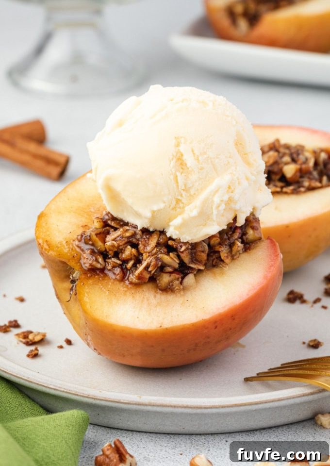 Baked apples cut on a plate with ice cream