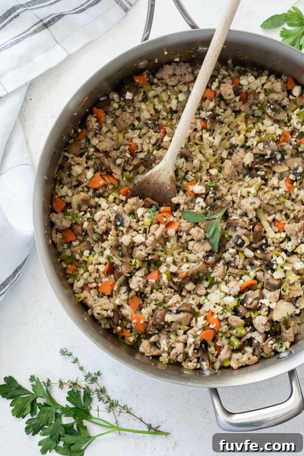 Low-Carb Cauliflower Rice Stuffing Recipe 6 Riced cauliflower stuffing with sausage in a skillet.