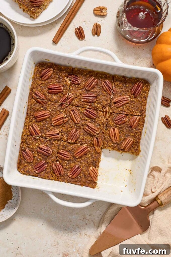 Baked Pumpkin Steel-Cut Oatmeal with Warm Spices 3 Pumpkin baked oatmeal cut into squares in baking dish.