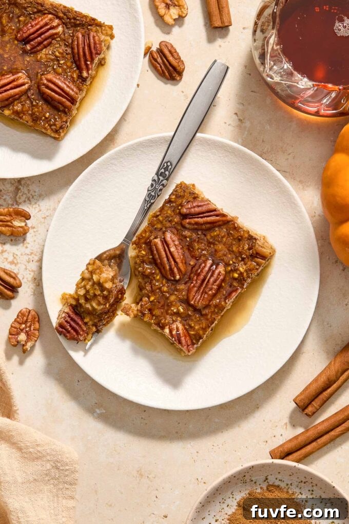 Oven-Baked Pumpkin Steel-Cut Oatmeal Recipe 6 Pumpkin Steel Cut Oat Baked Oatmeal on a plate with maple syrup.