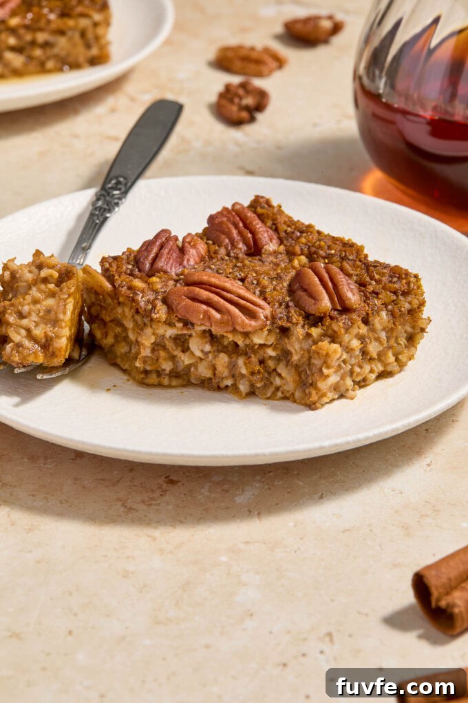 Baked Pumpkin Steel-Cut Oatmeal with Warm Spices 7 Baked pumpkin oatmeal topped with pecans on a plate.