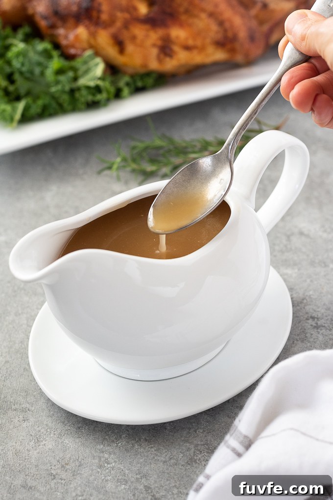 How to Make Turkey Gravy from Pan Drippings 5 Spoon drizzling gluten-free gravy into a gravy boat