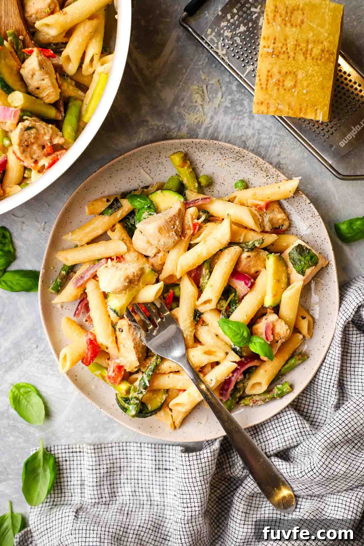 Creamy Chicken Pasta Primavera with Spring Vegetables 2 A plate of pasta primavera with a fork in it.