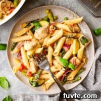 Creamy Chicken Pasta Primavera with Spring Vegetables 14 A plate of pasta primavera with a fork in it.