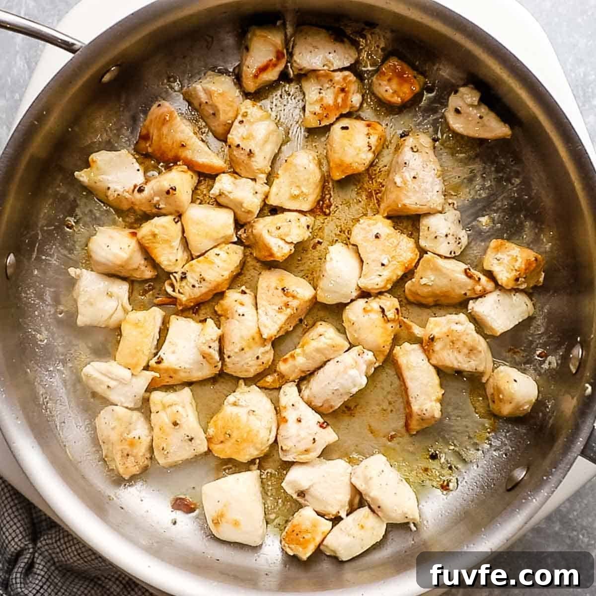 Creamy Chicken Pasta Primavera with Spring Vegetables 5 chicken cooking in a skillet