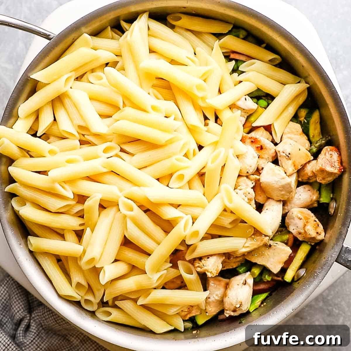 Creamy Chicken Pasta Primavera with Spring Vegetables 9 cooked chicken and pasta added to the skillet