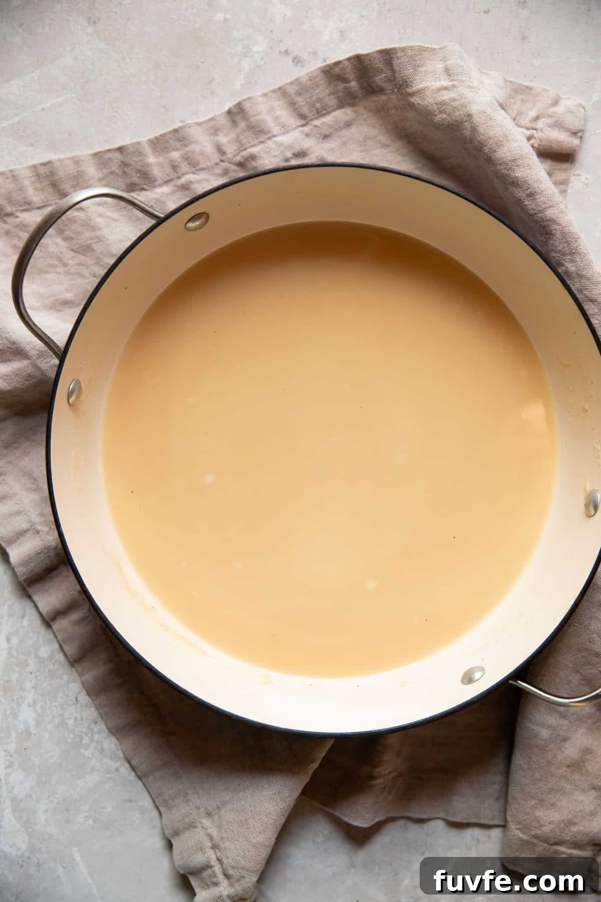 30-Minute Broccoli Cheddar Soup Recipe for Quick Comfort 7 cooked onions in a pot with broth