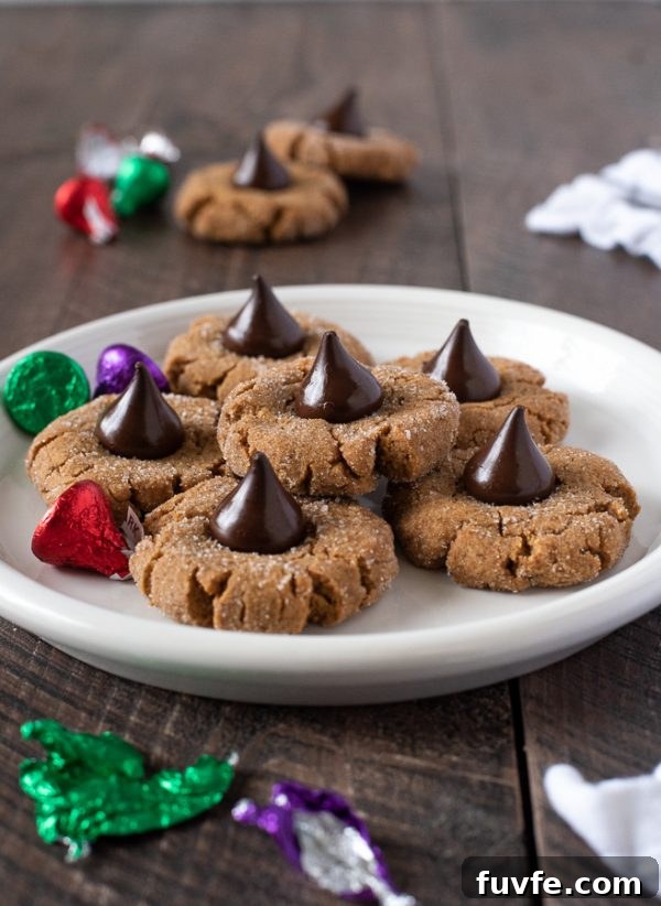 Gluten-Free Peanut Butter Blossom Cookies Recipe 3 gluten free peanut butter blossom cookies stacked on a white plate